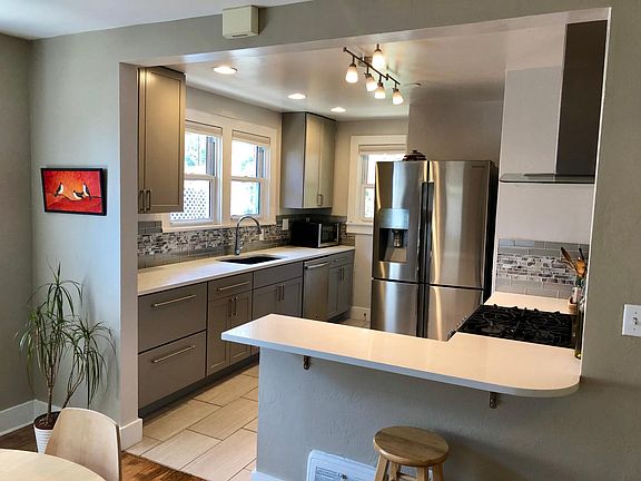 updated kitchen with quartz countertops and gas range