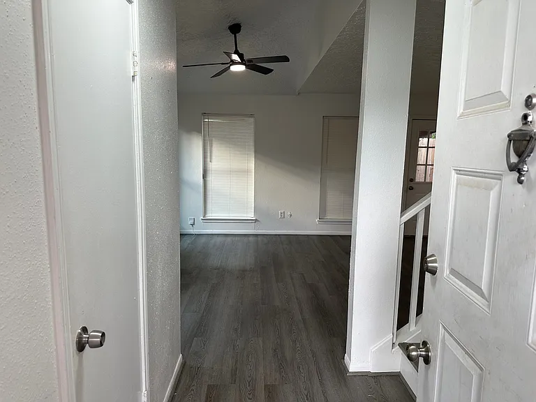 opening to house 1/2 bathroom to left and coat closet/ storage to right