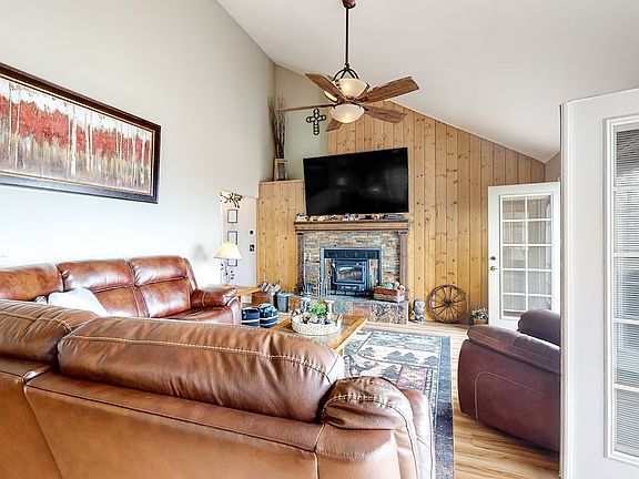 Fireplace in living room with deck access.