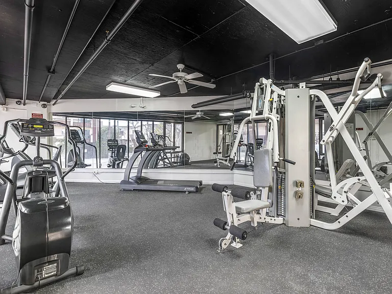 Feel the freedom of fitness under the comforting sway of the ceiling fan at Independence Plaza's state-of-the-art gym.