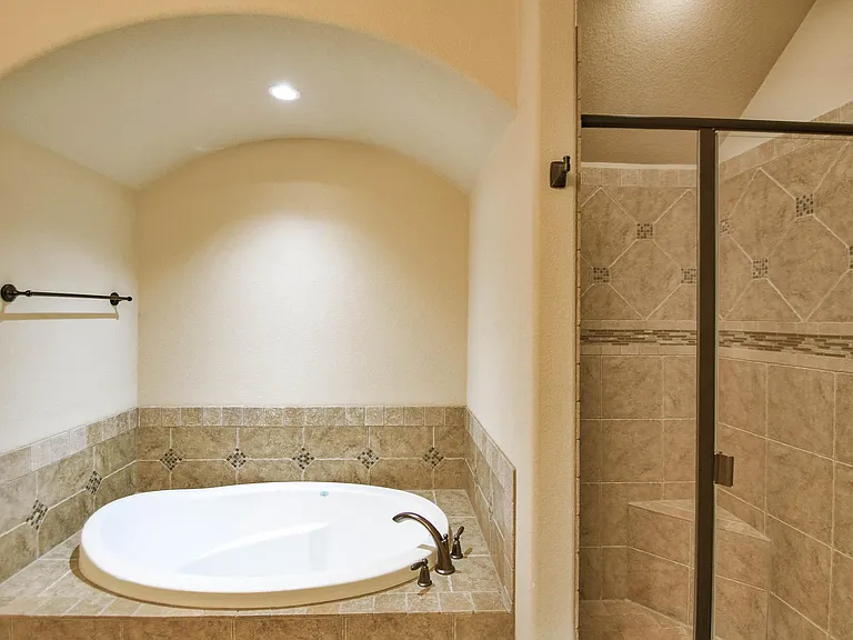 Tile shower and soaking tub in the Primary bathroom
