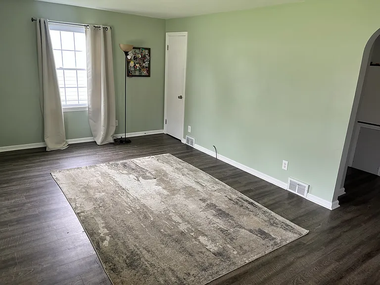 Living room - empty with coat closet.