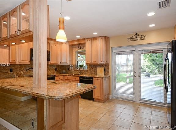 BEAUTIFULLY UPDATED KITCHEN, NEWER GE PROFILE APPLIANCES, CUSTOM LIGHTING, HURRICANE IMPACT FRENCH DOORS!