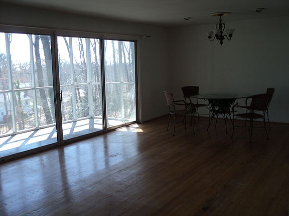 Hardwood floors in living/dining area with lots of light