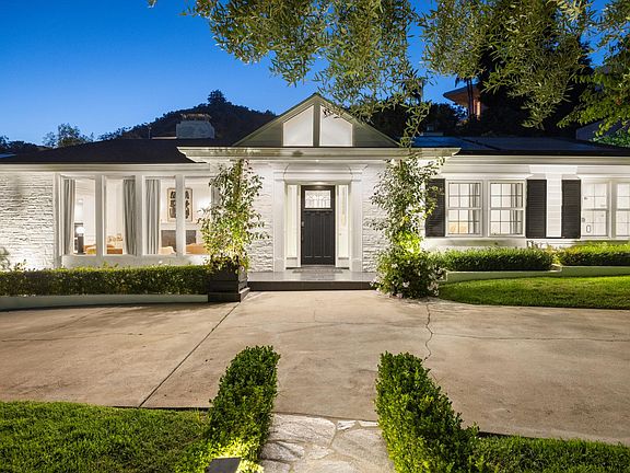 Approach the front of the house, where luxury meets serenity in this exclusive Beverly Hills estate.
