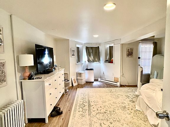 downstairs bedroom with newly installed faux wood floor