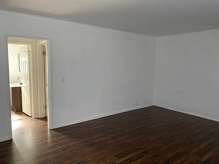 Living room with hallway to bathroom and bedroom