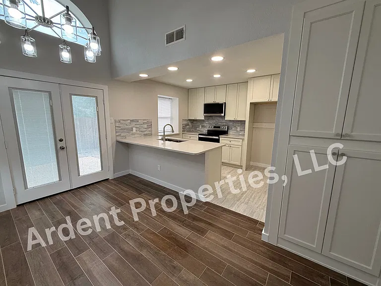 Open Kitchen and Back Door with built in blinds. Plenty of cabinetry for pantry items.