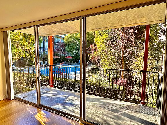 Unit #103 Private balcony overlooking the pool and landscaped backyard!