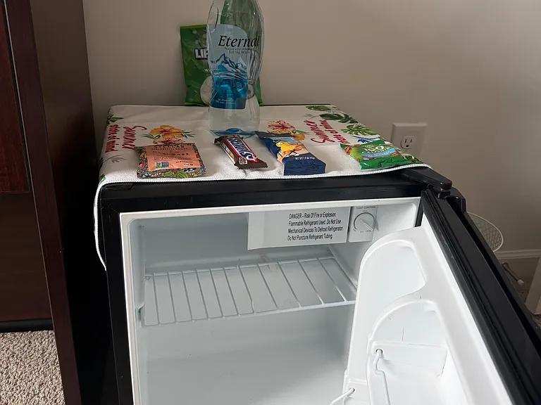 In-room mini fridge provides convenient cold storage for drinks and snacks, helping keep essentials close at hand.