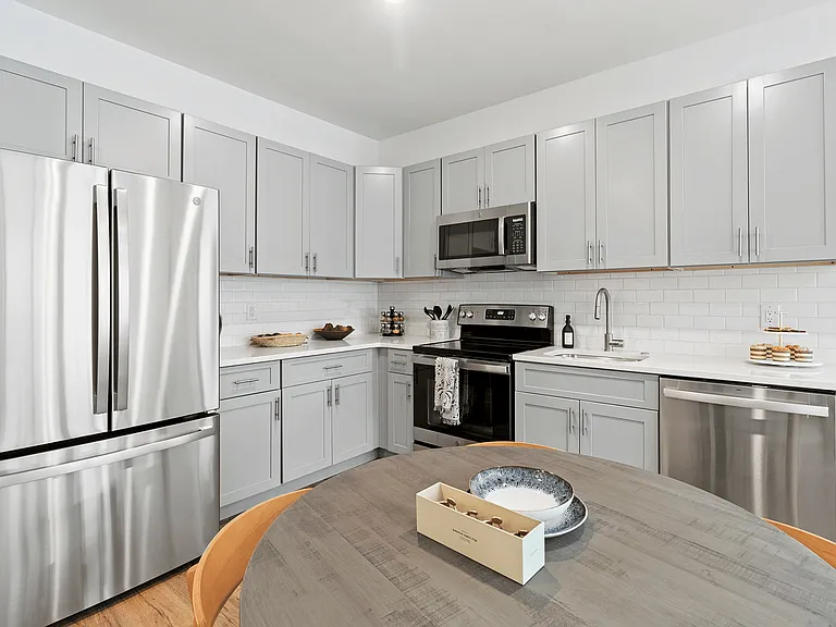 Explore the elegance of a modern kitchen featuring sleek appliances and stylish design.