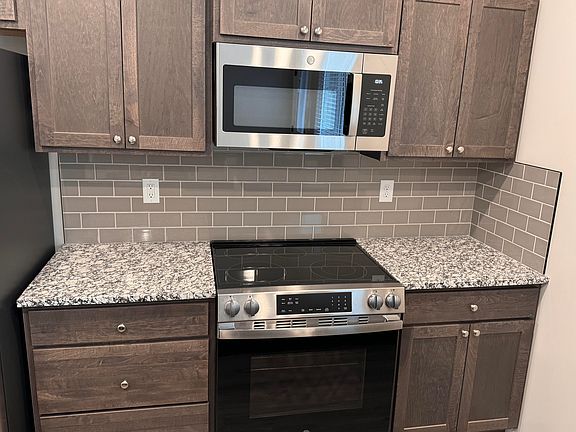Slide-in range with built-in micro. Subway tiles with granite counters.