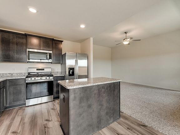 Enjoy stunning granite countertops and designer wood cabinetry in this kitchen.