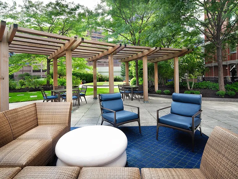 Outdoor courtyard with lounge seating and greenspace