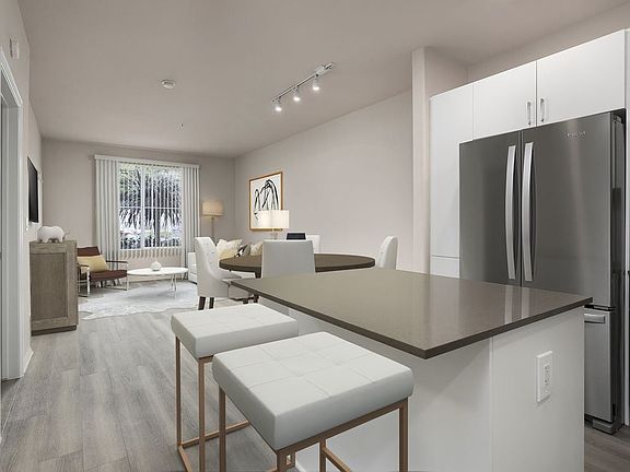 Renovated Package I kitchen with quartz countertops, white cabinetry, stainless steel appliances, hard surface vinyl plank flooring, and tile backsplash