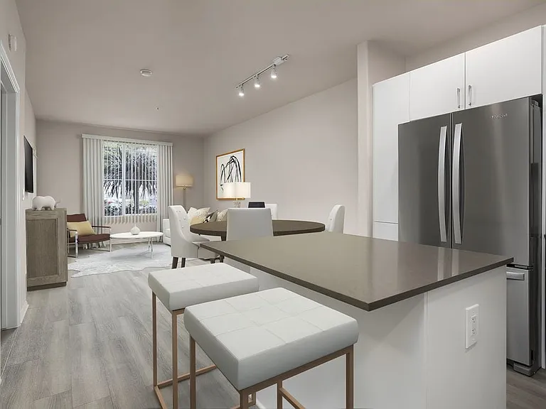 Renovated Package I kitchen with quartz countertops, white cabinetry, stainless steel appliances, hard surface vinyl plank flooring, and tile backsplash