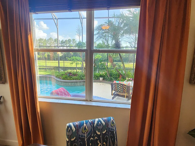Family room overlooking pool and pond.