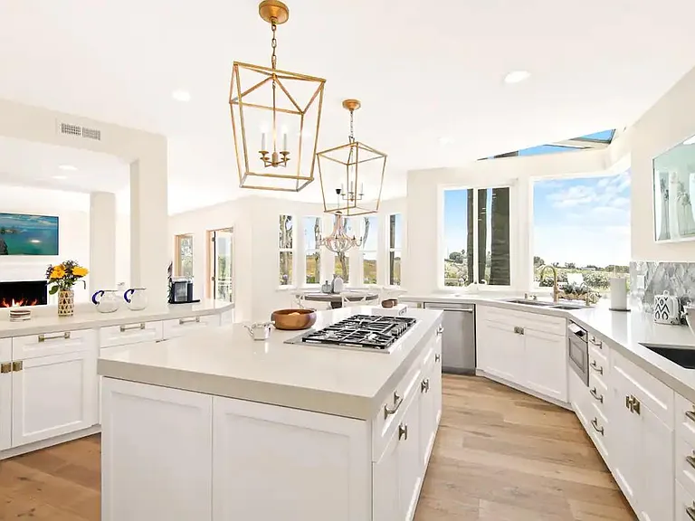 An entertainers dream kitchen with upgraded appliances overlooking the luxury outdoor space.