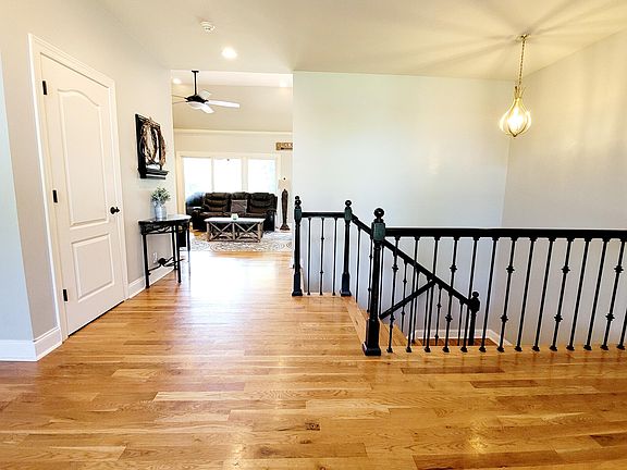 Foyer, stairs lead to lower level kitchen, rec room, and two master suites with private bathrooms