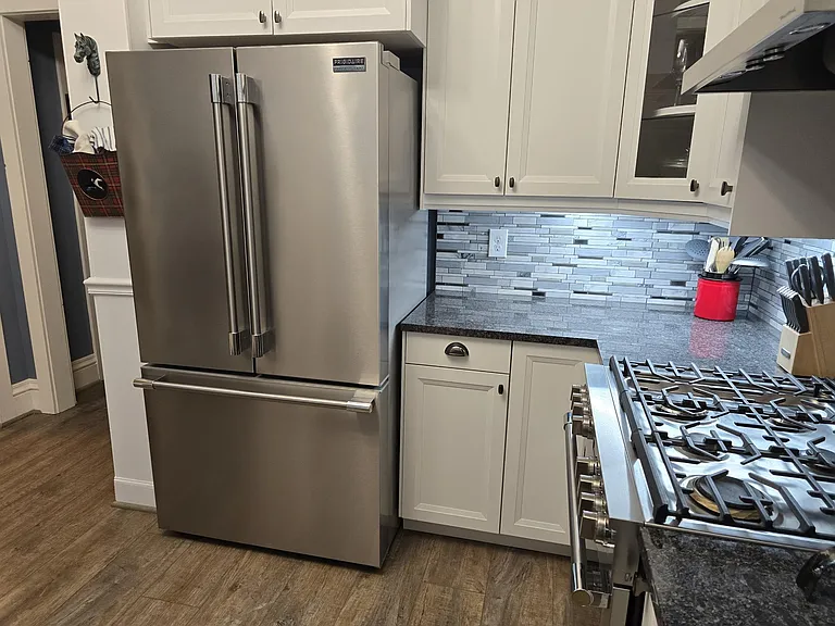 Refrigerator view with counter space.