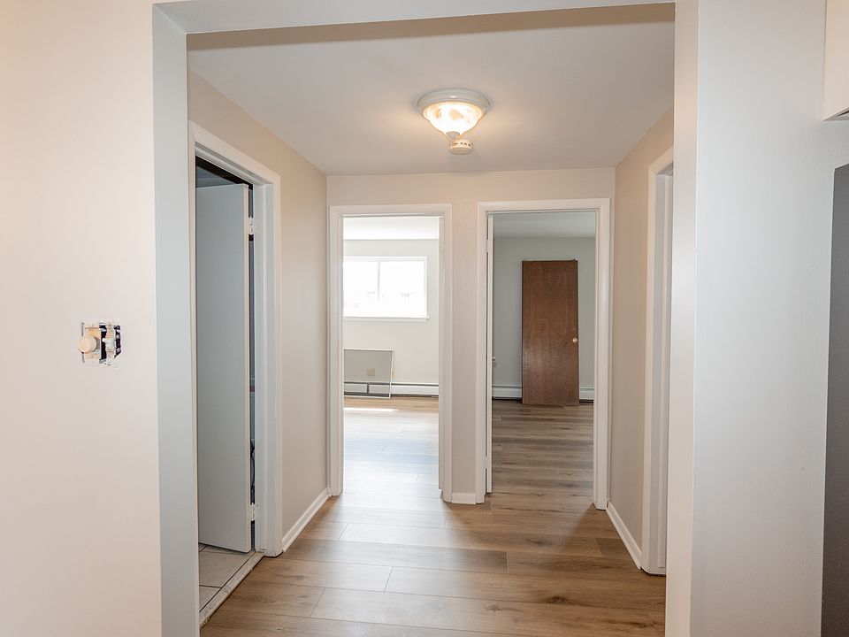 Hallway off kitchen leads to bathroom, linen closet, storage room and both bedrooms