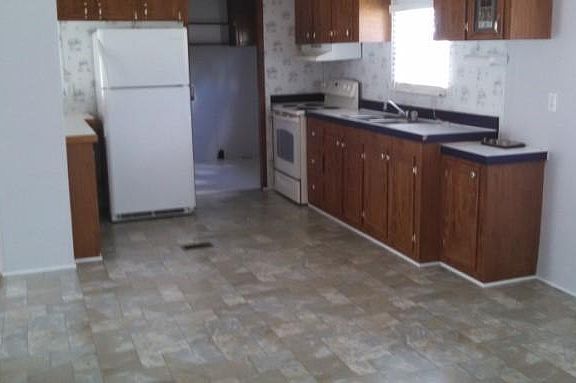 Kitchen with Laundry area in back and back entrance to home