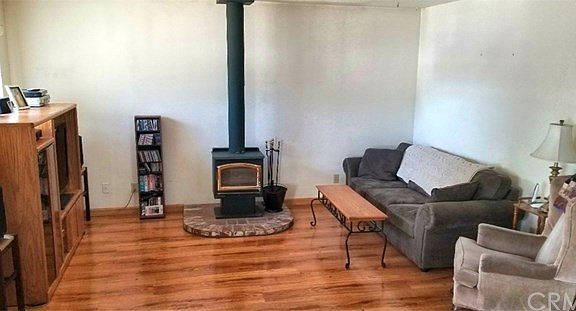 Living room with wood stove and laminate flooring