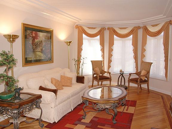 Grand Living Room with Crown Molding & Diagonal Hardwood Floors