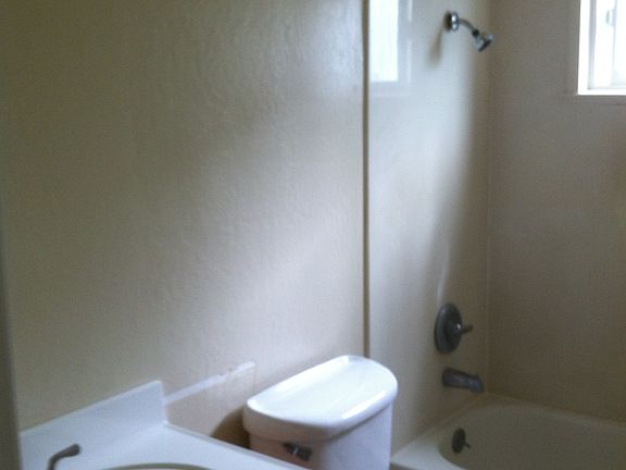 Remodeled bathroom with solid surface tub surround.  New vanity & fixtures
