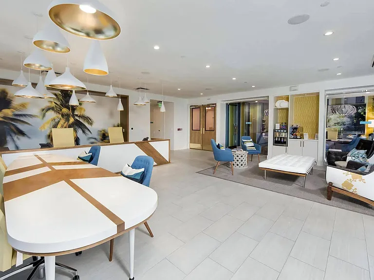 Leasing Office with Modern Desks, Lounge Seating, and Coffee Bar