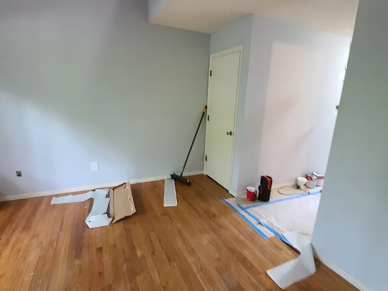 This photo is from when this unit was rented in 2021. looking from dining room to living room, basement stairs and entry hall