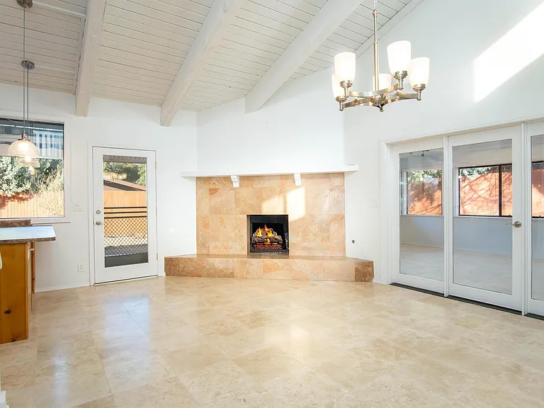 Dining area and gas fireplace. To the right is a massive flex space with numerous windows. Could be an office, playroom, yoga space or even another bedroom.