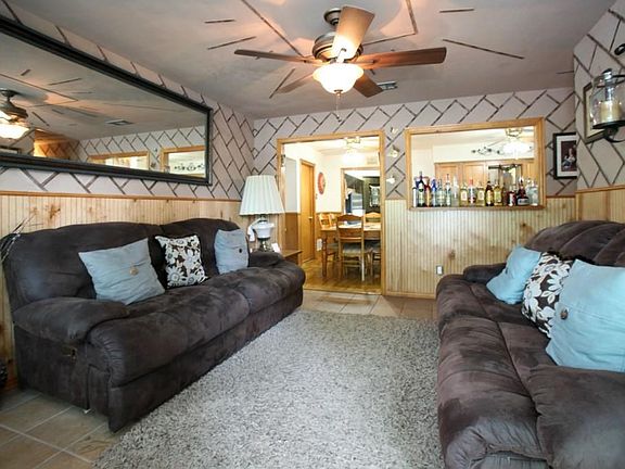 Living room with a view of the breakfast area. The half window is open to the kitchen.