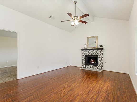 Den with vaulted ceilings, recently redone tile, gas, and laminate floors.