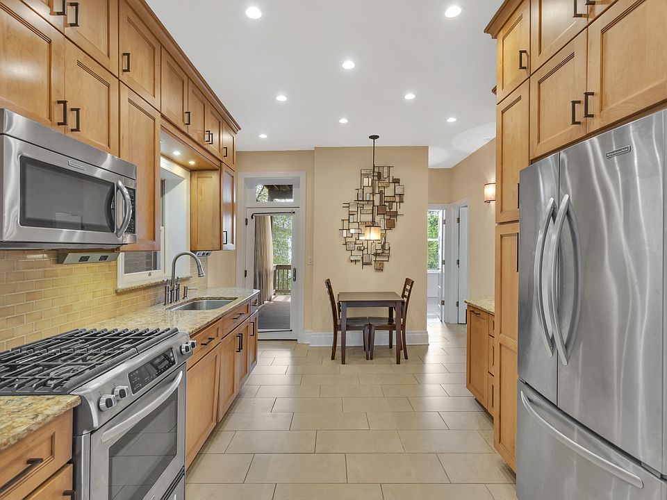 Kitchen has quartz counters, stainless appliances, and custom cabinetry.