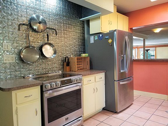 Galley Kitchen with newer appliances and skylights