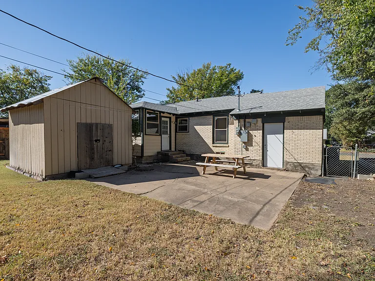 Spacious fenced backyard perfect for pets, games, or relaxing outdoors. Enjoy a picnic table, open lawn, and peaceful neighborhood views under the Texas sun.