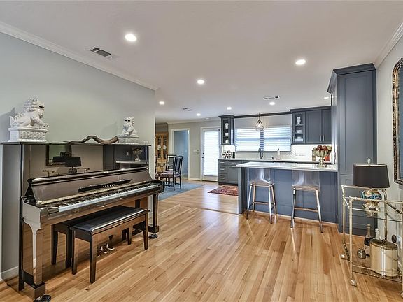 Recessed LED lighting and bright modern lines enhance the open concept 4/3 family home.