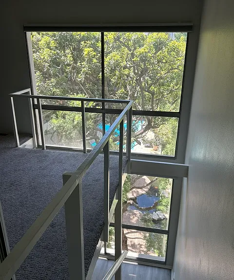 Wall of windows overlooking pool/koi pond
