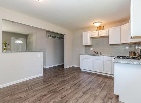 Kitchen opens to living room to offer an open concept feel and provide easy entertaining with guests