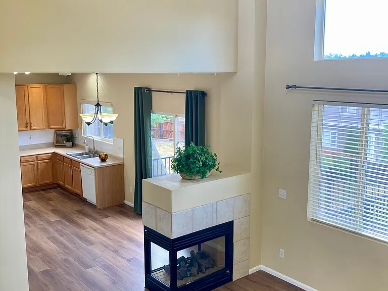 Three face fireplace between great room and the kitchen. Great room has high celling.