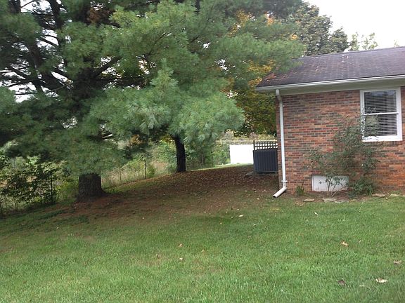 Surrounded by pasture behind and to one ide of the pr