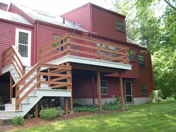 Deck overlooks private backyard.