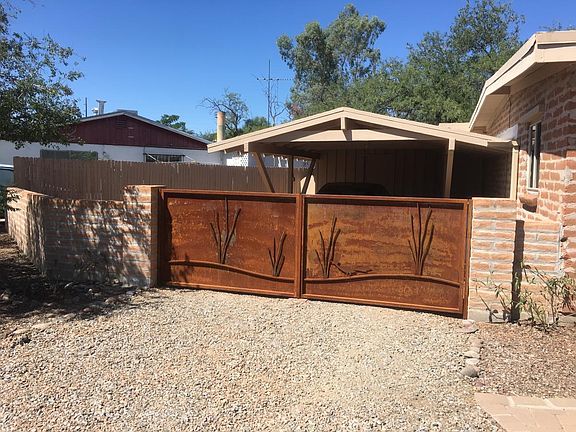 Beautiful Iron Gated Carport (Wood fence in background is now upgraded metal fence)