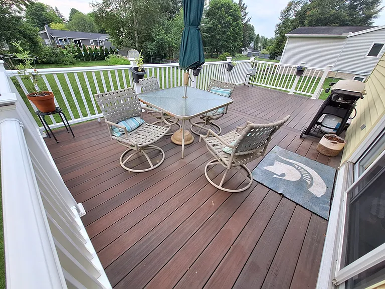 Large trex deck off of dining room overlooks the back yard