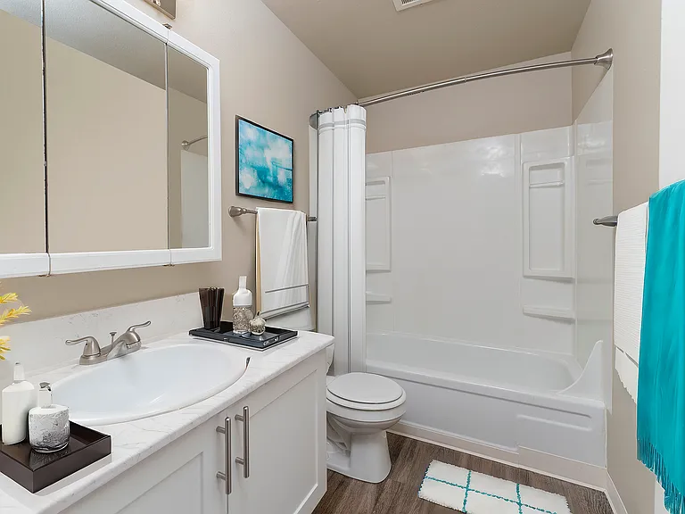 Experience the elegance of this bright and modern bathroom, featuring sleek fixtures and a calming color scheme.