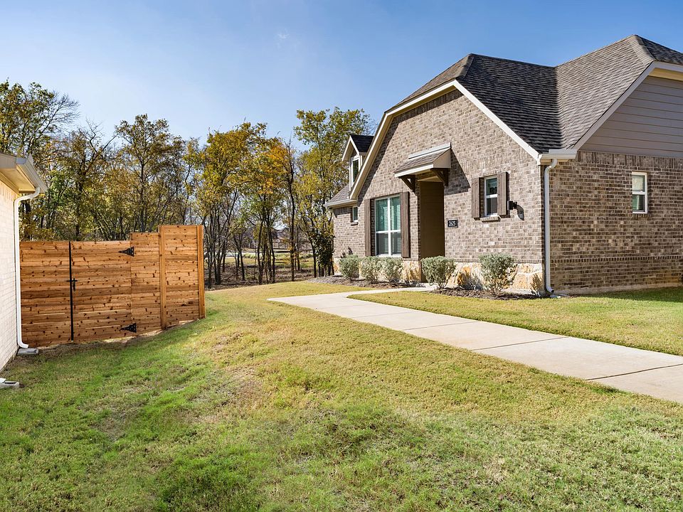 A private side yard and dedicated entry add separation and ease, offering a quiet approach to daily living within this single-family cottage.