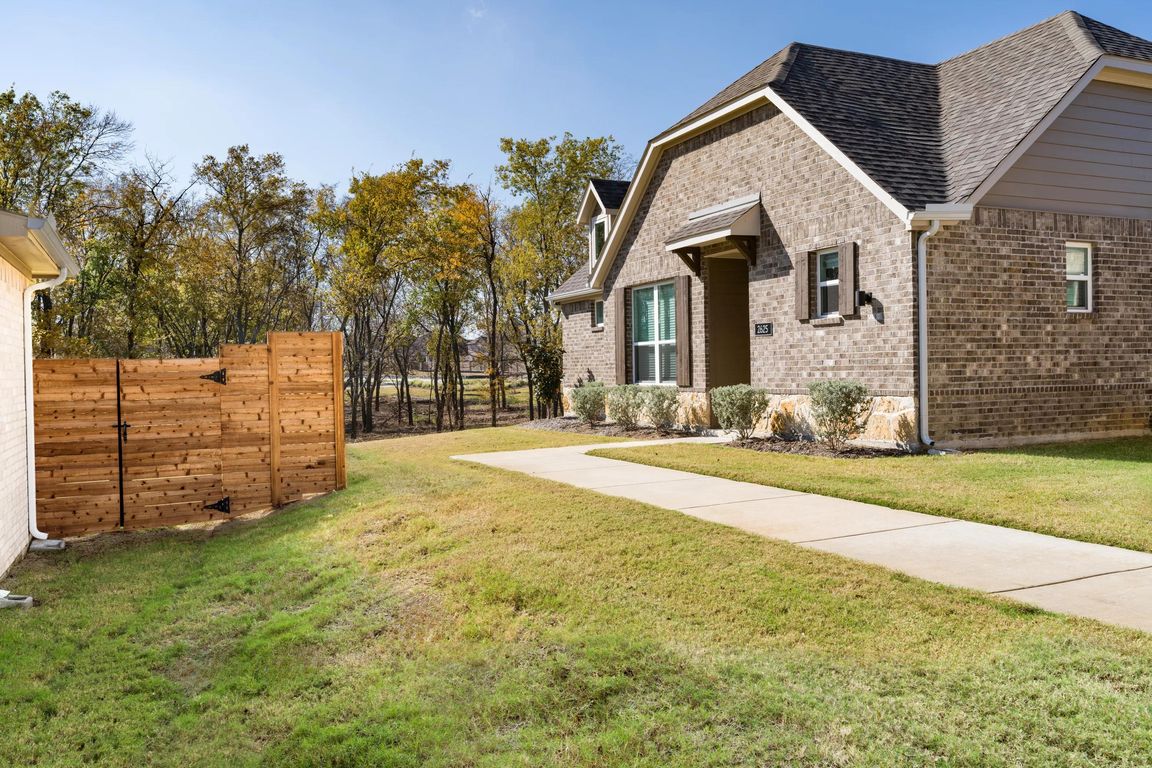 A private side yard and dedicated entry add separation and ease, offering a quiet approach to daily living within this single-family cottage.