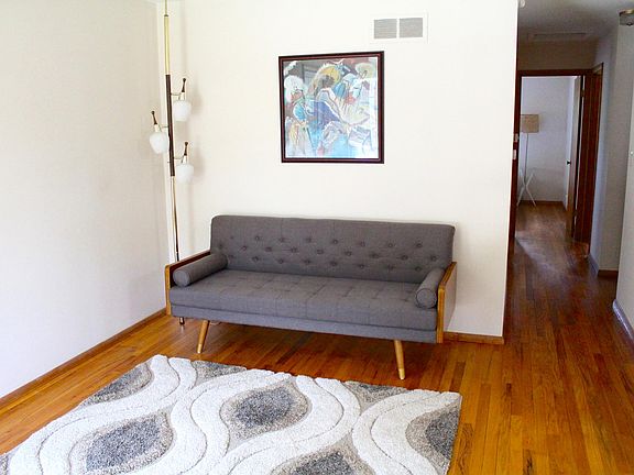 Living room with the hallway to the bedrooms and bathroom.