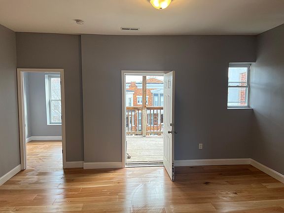 Living room leading to a deck on the right and den/office on the left